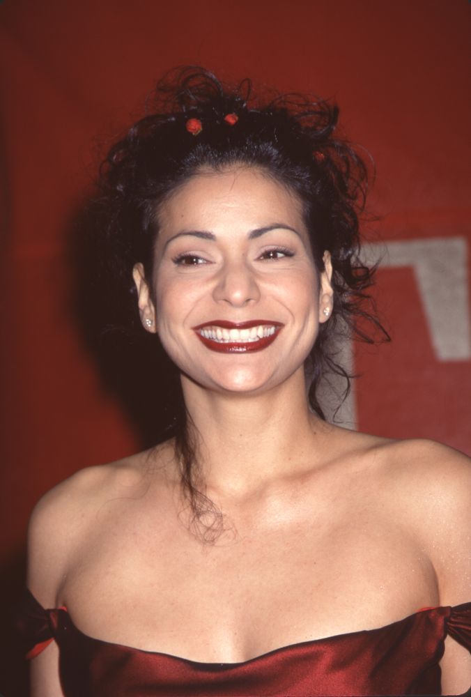 Constance Marie closeup photo print from the 1999 Alma Awards in red off-shoulder dress with flowers in hair.