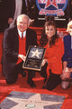 Photo print of Paula Abdul in front of Hollywood star with Mayor Johnny Grant