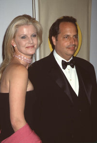 Maeve Quinlan in strapless dress with Jon Lovitz in tuxedo photo print.