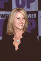 Maeve Quinlan in black top and silver necklace with blue charm photo print