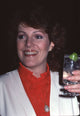 Close-up photo print of Lynn Redgrave holding a drink in a re-collared shirt.