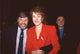 Lynn Redgrave in red jacket with John Clark in suit and blue striped shirt photo print.