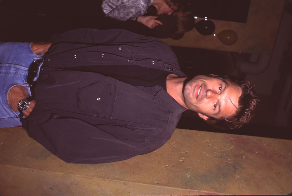 Harry Hamlin photo print at 'Newsroom' opening, stylish black shirt and jeans.
