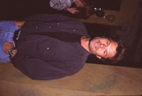 Harry Hamlin photo print at 'Newsroom' opening, stylish black shirt and jeans.