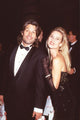 Harry Hamlin in tuxedo and Nicollette Sheridan in black dress photo print.