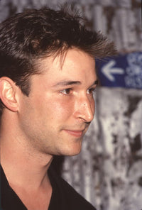 Noah Wyle close-up profile photo print in black jacket.