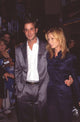 Noah Wyle in silver suit and Tracy Warbin in navy outfit at 'Batman & Robin' premiere photo print.