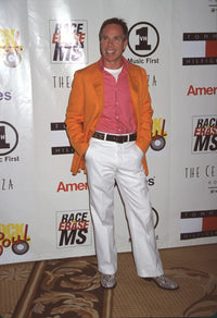 Tommy Hilfiger in orange jacket, pink shirt and white pants at Rock & Soul To Erase MS event - Photo Print