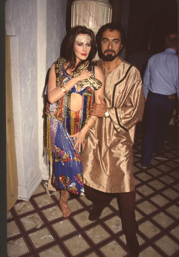 Hunter Tylo holding a snake with Kabir Bedi on the set of Bold & Beautiful photo print