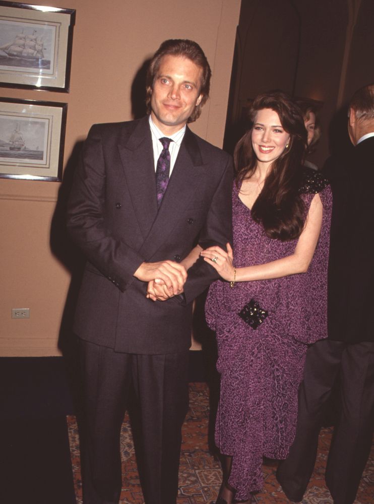 Michael Tylo in double-breasted suit and Hunter Tylo in purple dress photo print.