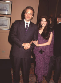 Michael Tylo in double-breasted suit and Hunter Tylo in purple dress photo print.