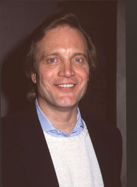 Close-up photo print of Michael Tylo in a sweater, striped shirt, and blazer