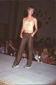 Tommy Hilfiger fashion show model wearing brown pants and cream tank top photo print.