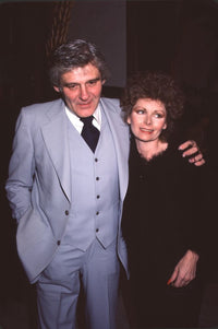 Richard Schaal in gray suit and Tasha Brittain in black photo print