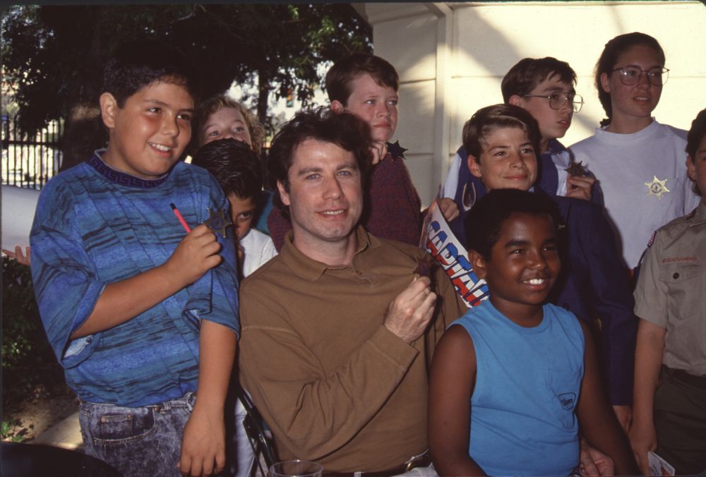 John Travolta with children at a Scientologist event photo print