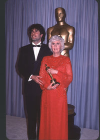 John Travolta in tuxedo and Barbara Stanwyck in red gown at Academy Awards photo print.