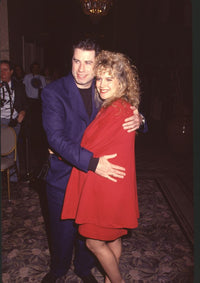 John Travolta hugging Kelly Preston in red outfits photo print