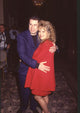 John Travolta hugging Kelly Preston in red outfits photo print