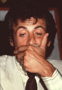Close up photo print of Sylvester Stallone holding face.