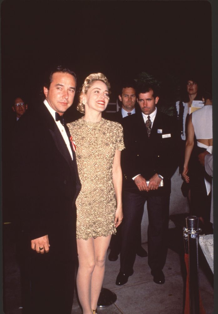 Bill Macdonald in tuxedo with Sharon Stone in gold mini dress at the 65th Academy Awards.