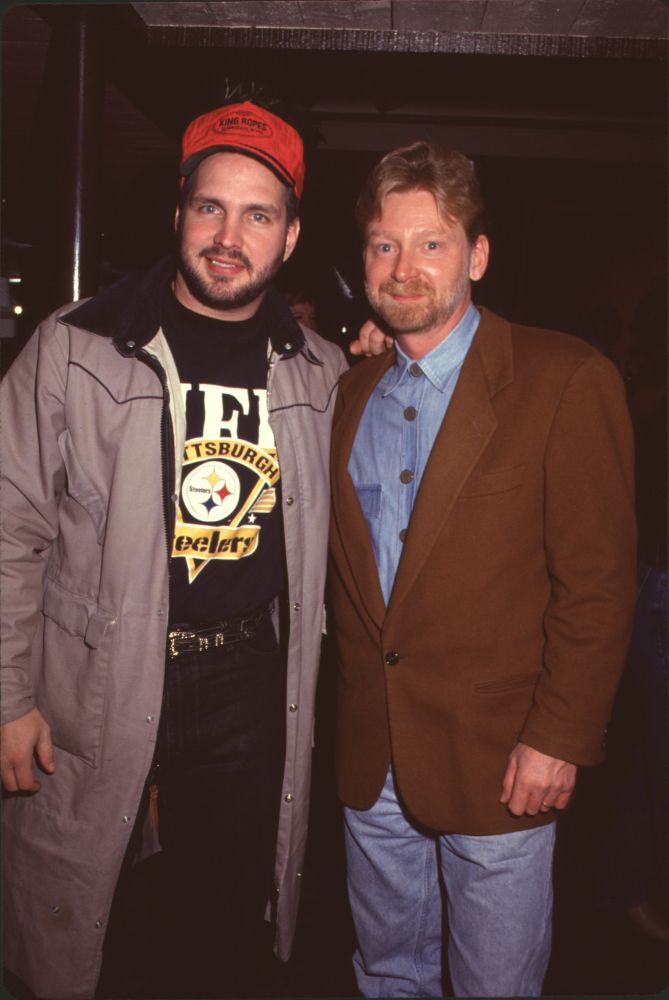 Garth Brooks photo print at NBC party in a trench coat with Warren Littlefield.