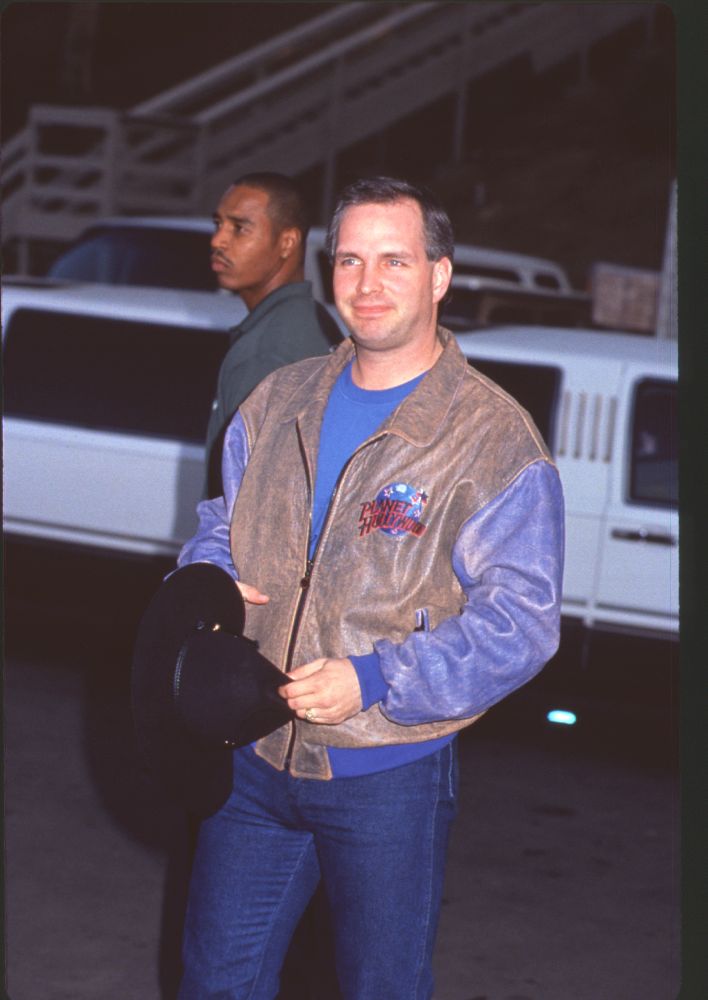 Garth Brooks photo print in jeans and brown leather jacket at Billboard Music Awards.