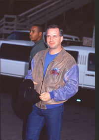 Garth Brooks photo print in jeans and brown leather jacket at Billboard Music Awards.