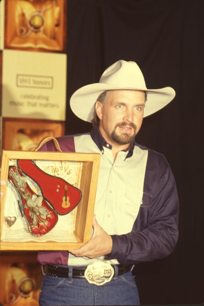 Garth Brooks holding award at the 1st Annual VH1 Honors photo print.