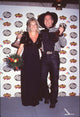 Sandy Brooks holding flowers in a black dress with Garth Brooks at the ACM Awards photo print