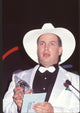 Garth Brooks close-up photo print in white tuxedo holding award.