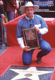 Garth Brooks photo print in front of Hollywood star holding plaque.