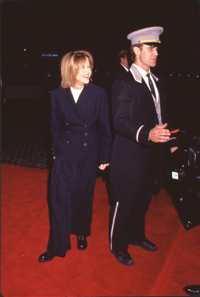 Meg Ryan at the 51st Golden Globes wearing striped pants and double-breasted jacket.
