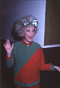 Phyllis Diller photo print in red and white sweater with Dalmatian bow in hair.