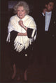 Phyllis Diller wearing black dress and white fur at Gershwin Anniversary Party photo print.