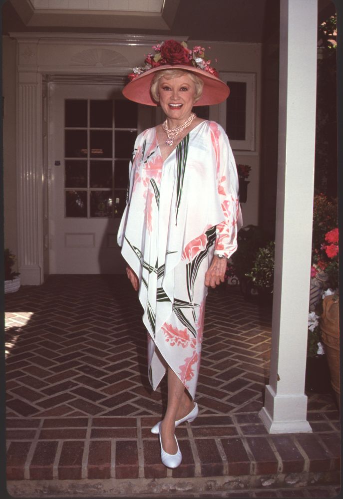 Phyllis Diller in white flowy dress and large pink floral hat photo print