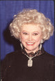 Phyllis Diller close-up photo print in black top with lace collar.