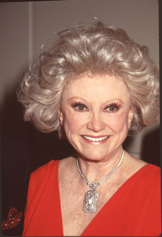 Phyllis Diller close-up photo print in red top and silver choker.