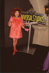 Phyllis Diller in orange and pink fur next to Universal Studios Hollywood sign photo print.