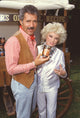 Photo print of Alex Trebek holding a can of beans with Phyllis Diller.
