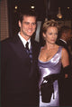 Jim Carrey in black suit with Lauren Holly in black satin dress at Fire & Ice Ball