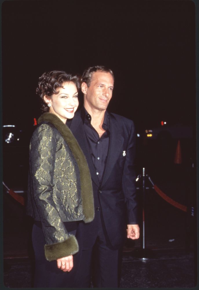 Ashley Judd in green coat with fur trim and Michael Bolton in black suit photo print.