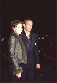 Ashley Judd in green coat with fur trim and Michael Bolton in black suit photo print.