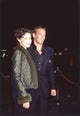 Ashley Judd in green coat with fur trim and Michael Bolton in black suit photo print.