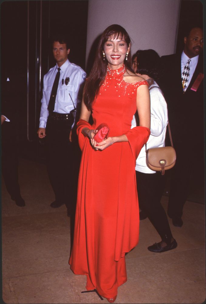 Barbara Carrera in a red gown and shawl at the American Cinema Awards photo print.