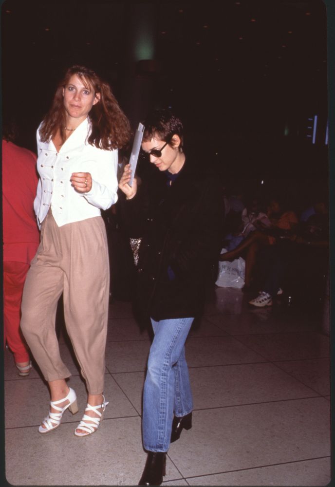 Winona Ryder stylish photo print at LAX in jeans and black blazer.