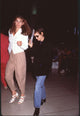 Winona Ryder stylish photo print at LAX in jeans and black blazer.