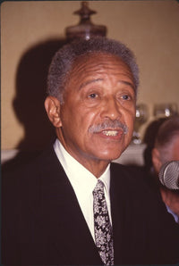 David Dinkins speaking into a microphone photo print.