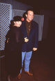 Roseanne Barr in black dress with pink flower and Tom Arnold in navy blazer photo print.