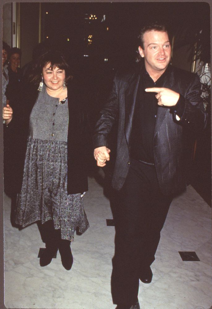 Roseanne Barr in gray dress and black jacket with Tom Arnold in black suit photo print.