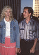 Daryl Hannah in pink skirt and denim jacket with Jackson Browne in gray striped shirt - Photo Print